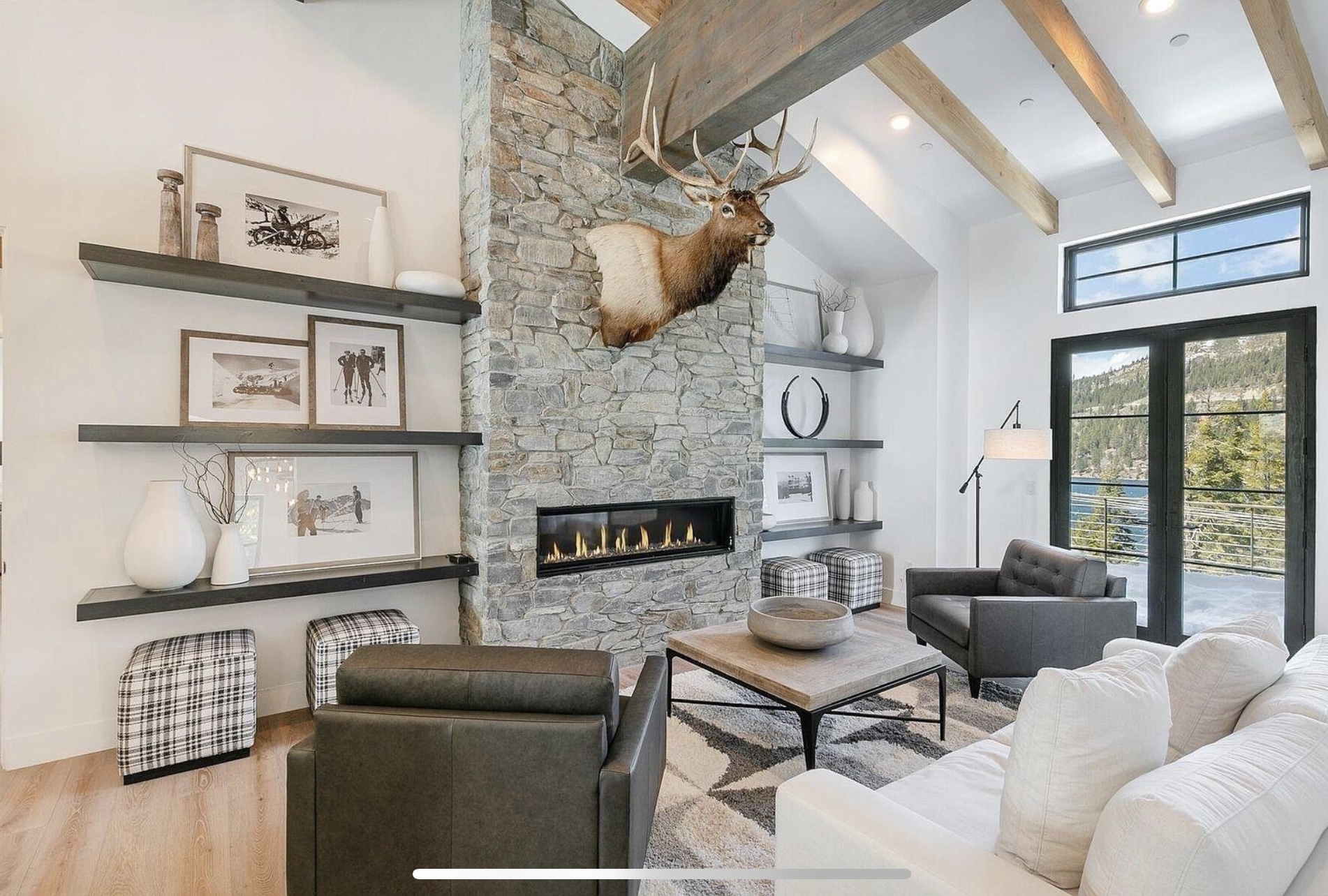 Stone fireplace rising to the beamed ceiling in the main living room