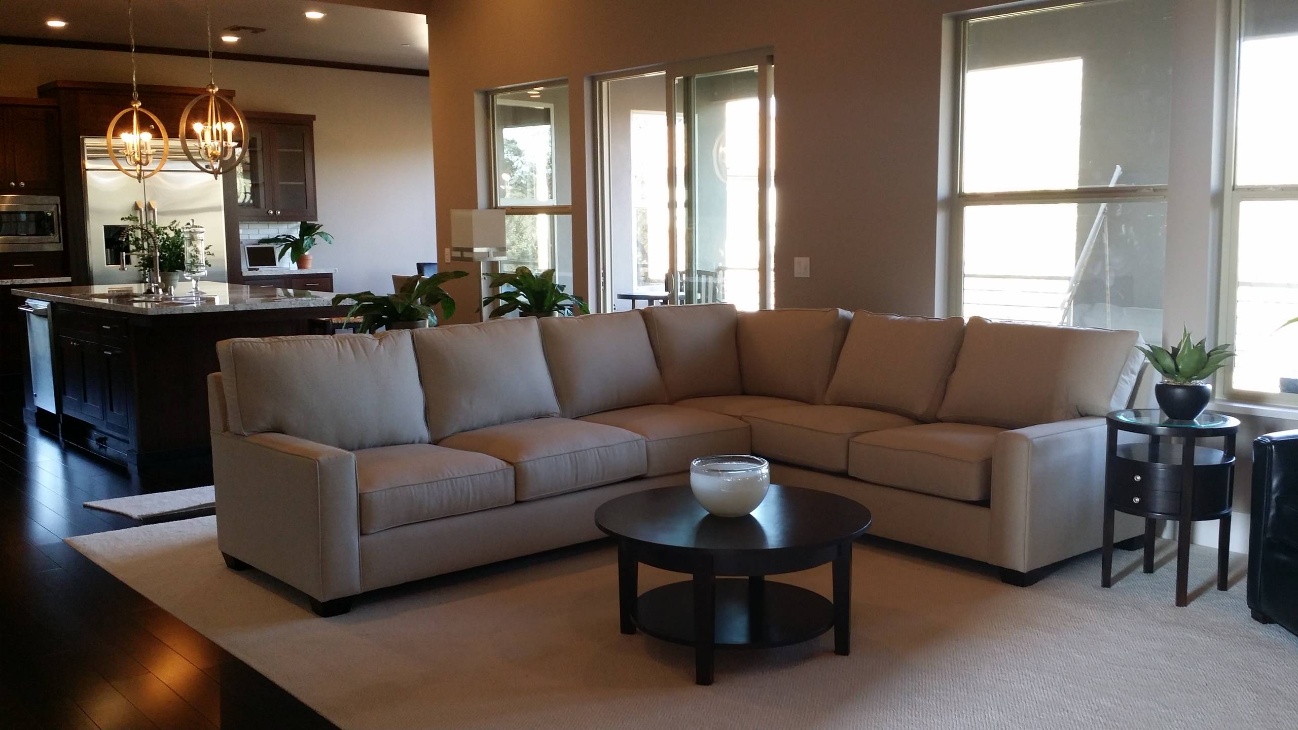 Living room with a sectional sofa and garden-facing windows