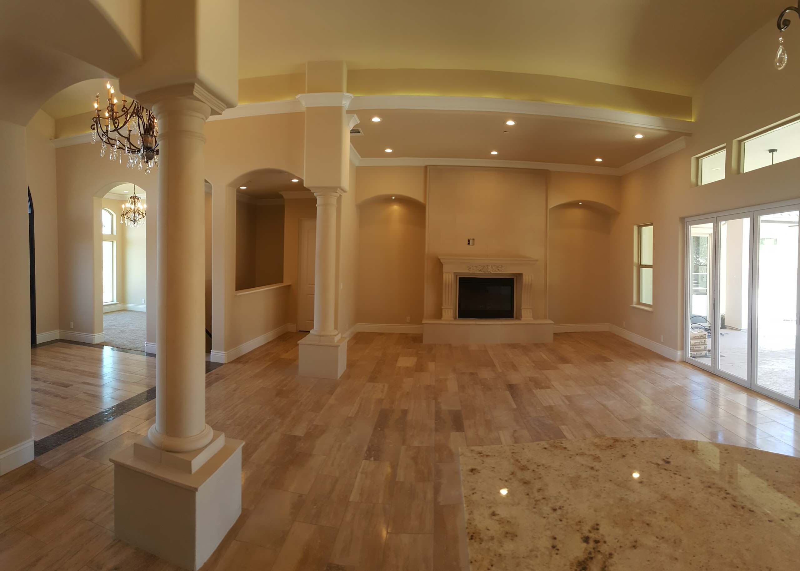 Great room with a fireplace, recessed niches and broad windows