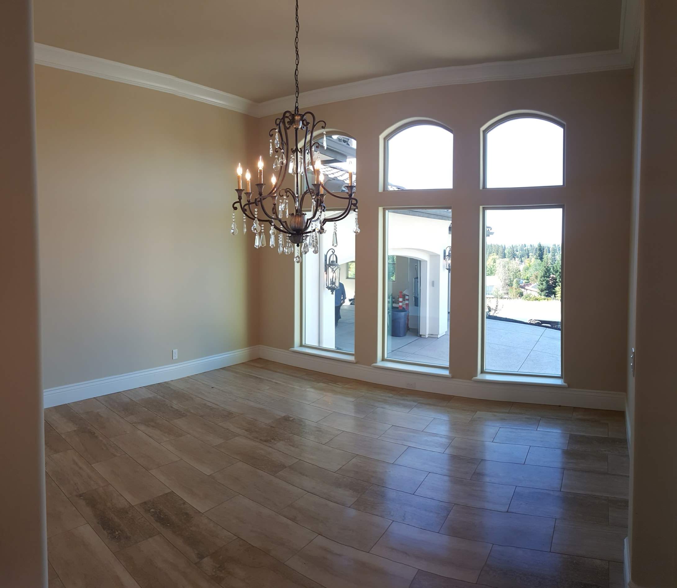 Light-filled room with arched windows and a chandelier