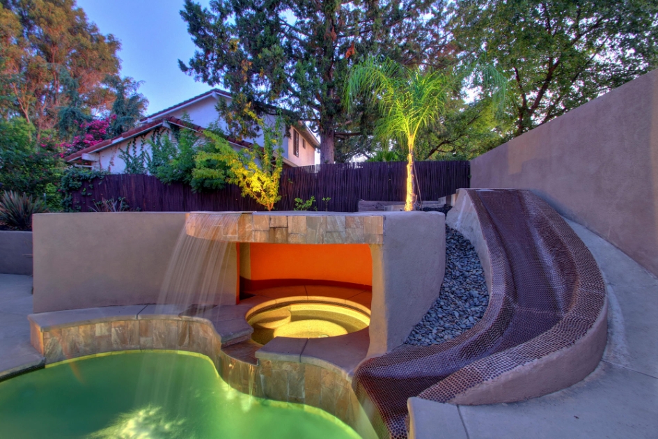Poolside waterfall and curved slide