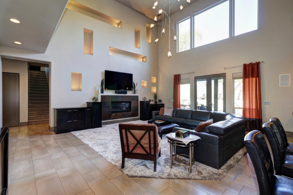 Light-filled living room with high windows and a fireplace