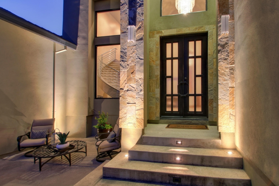 Stone-clad entry with warm evening lighting