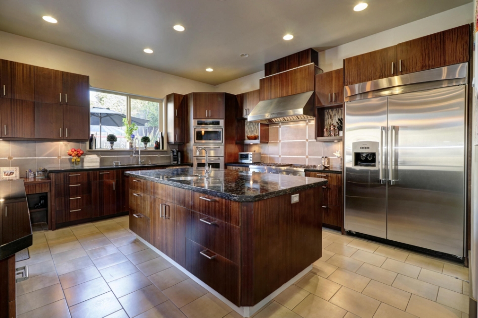 Kitchen with a central island and rich wood cabinetry