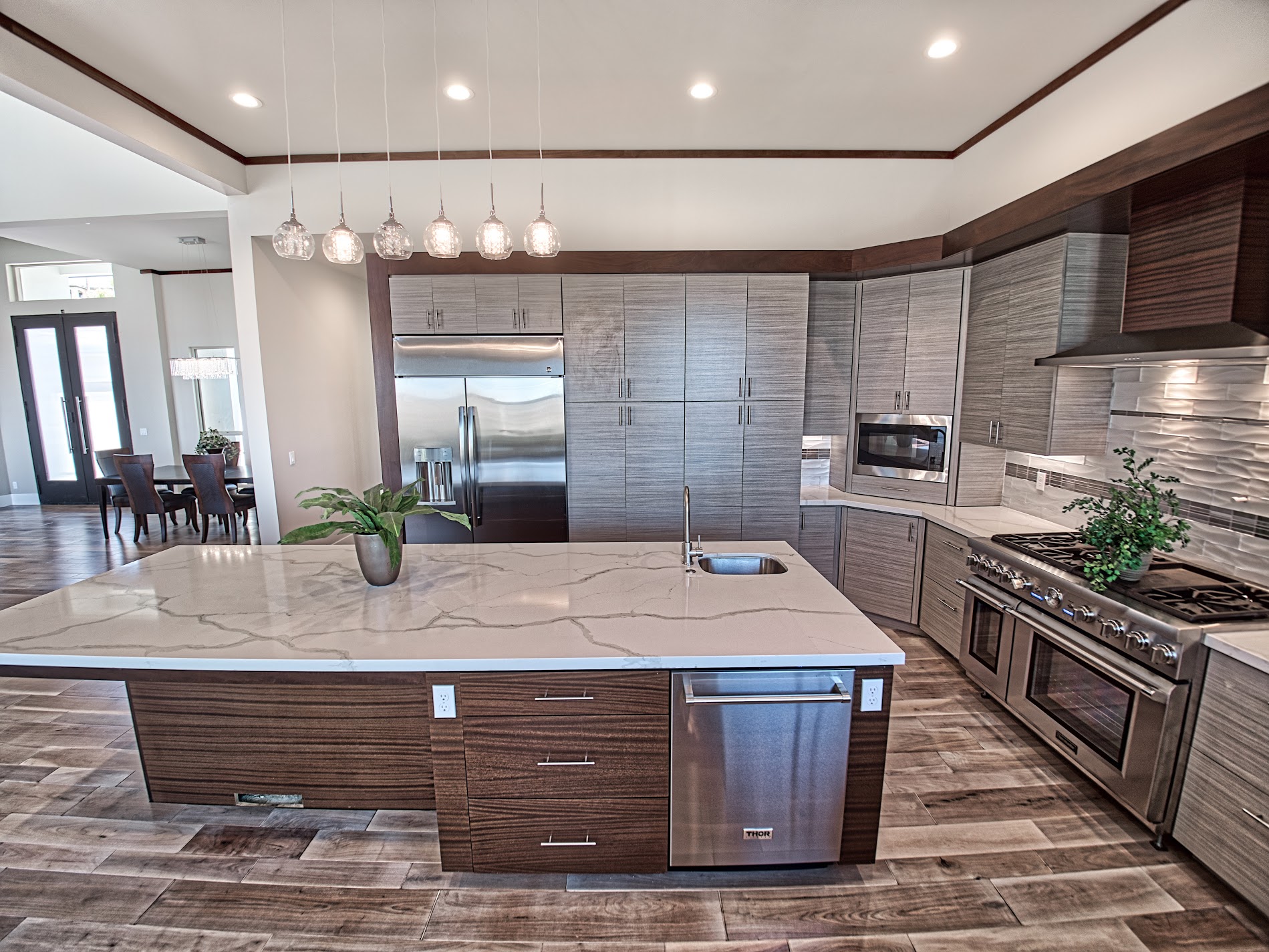 Custom kitchen with a waterfall island and warm wood cabinetry