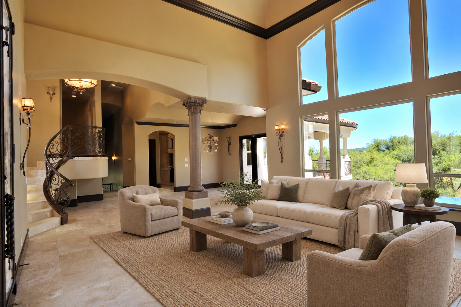 Double-height living room with a curved staircase and tall windows